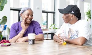 people talking over coffee in a cafe